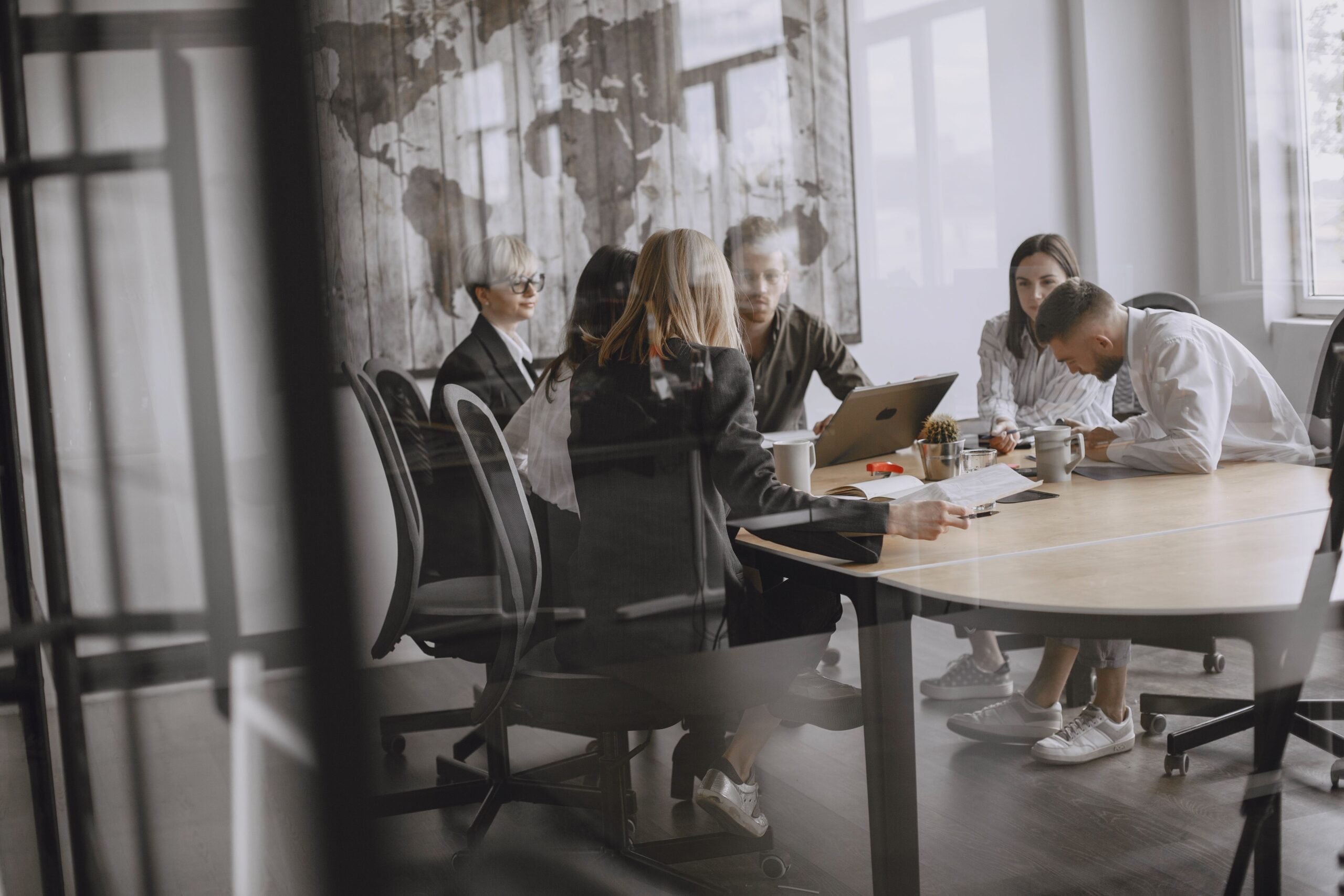 Professionals in a meeting room engaged in a collaborative business discussion.